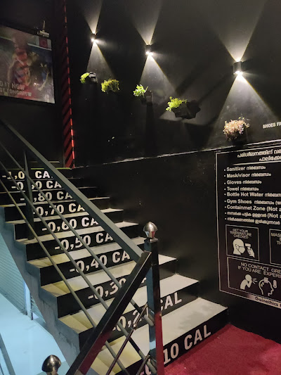 Industrial black-and-orange entrance area of the gym